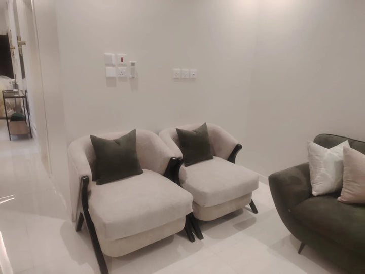 Pair of cream accent chairs with dark timber arms