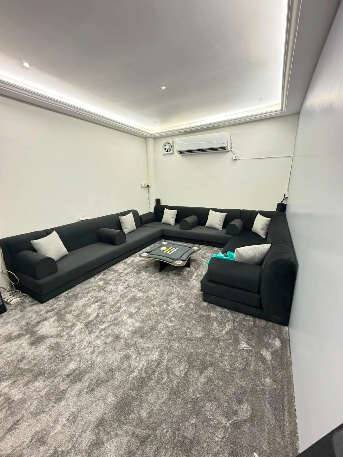 Black majlis seating arrangement with silver cushions