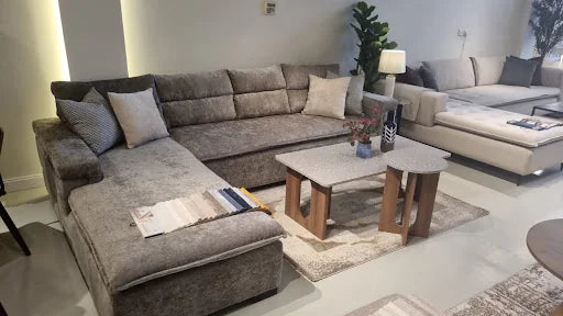 Grey sectional with nested tables in a finished Riyadh living room