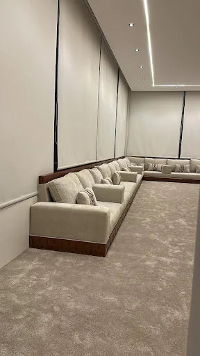 Custom upholstered majlis seating along a Riyadh room perimeter