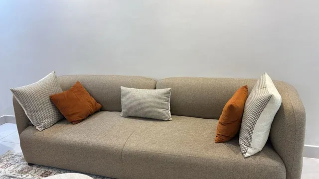 Taupe sofa and contrasting cushions — KLIK customer-home photograph