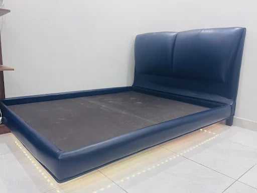 A blue upholstered bed after installation — KLIK customer-home photograph
