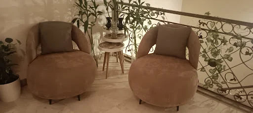 A pair of rounded armchairs — KLIK customer-home photograph