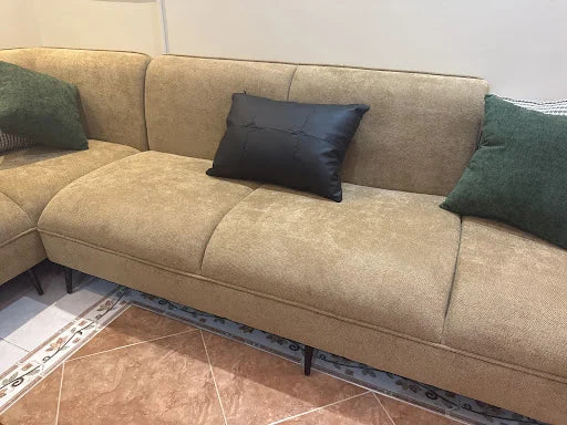 A neutral sofa with contrasting cushions — KLIK customer-home photograph