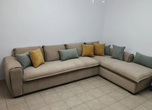 Grey corner sofa with colourful cushions — KLIK customer-home photograph