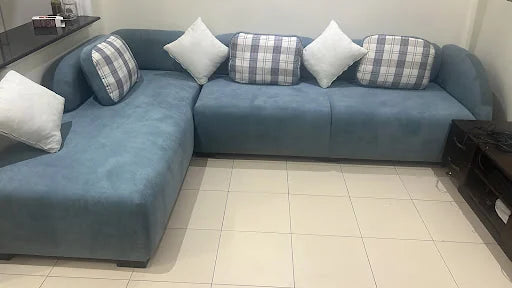 Blue corner seating with checked cushions — KLIK customer-home photograph