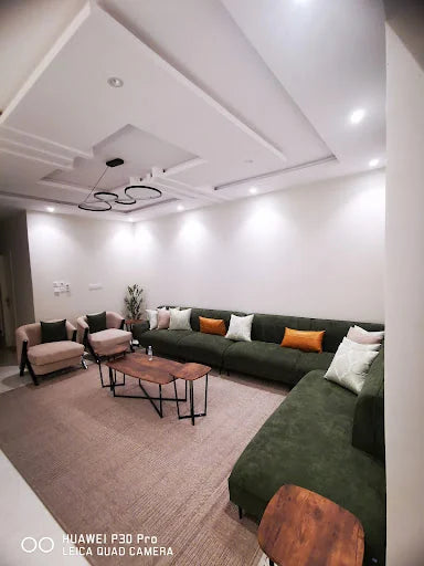 A long green majlis in a family room — KLIK customer-home photograph