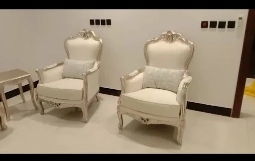 A pair of classic cream armchairs — KLIK customer-home photograph