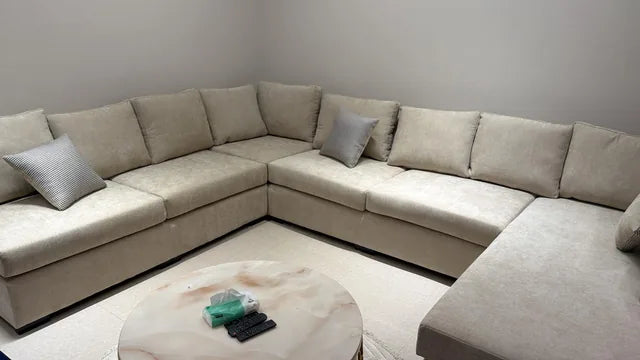 A neutral corner sofa after delivery — KLIK customer-home photograph