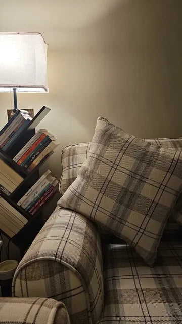 Checked upholstery beside a reading corner — KLIK customer-home photograph