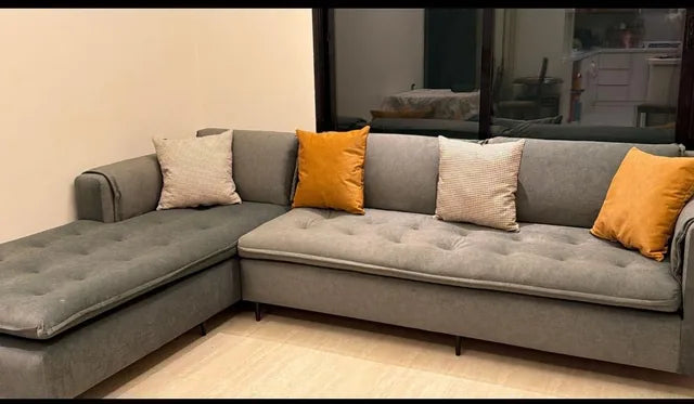 Grey corner seating with mustard cushions — KLIK customer-home photograph