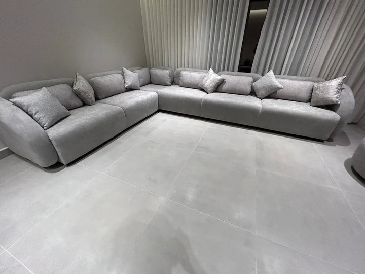 Silver-grey modular corner sofa installed in a modern customer living room