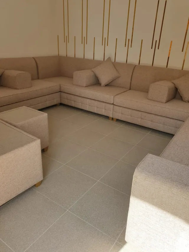 Beige majlis seating suite with matching ottomans