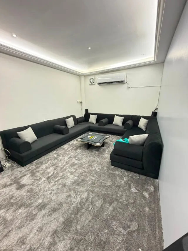 Black majlis seating arrangement with silver cushions
