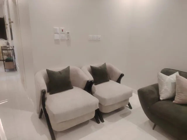 Pair of cream accent chairs with dark timber arms