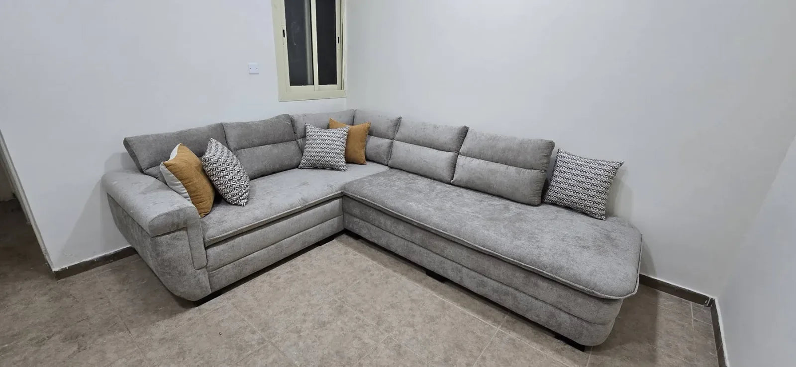 Complete light-grey corner sofa with coordinated cushion styling in Jeddah