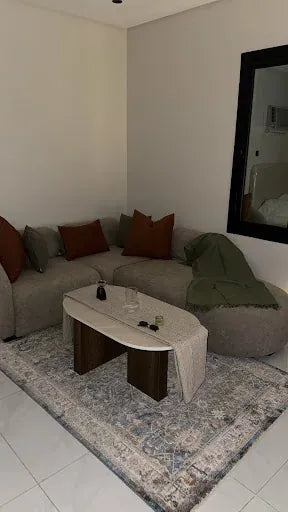 Grey corner sectional styled with a curved coffee table