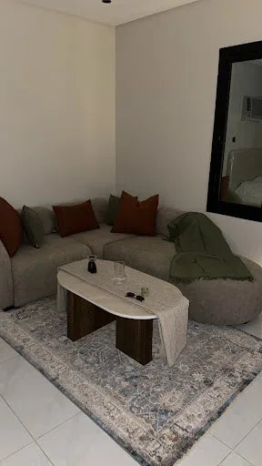 Grey corner sofa styled with a curved coffee table