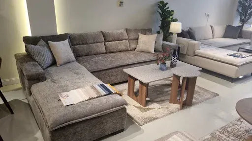 Grey sectional with nested tables in a finished Riyadh living room