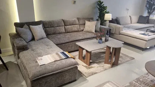 Grey corner sofa with nested tables in a finished Riyadh living room