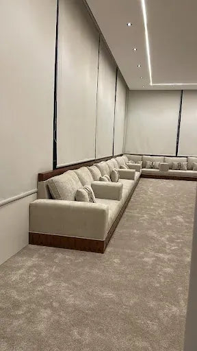 Custom upholstered majlis seating along a Riyadh room perimeter